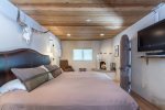 Master bedroom with king bed and kiva fireplace